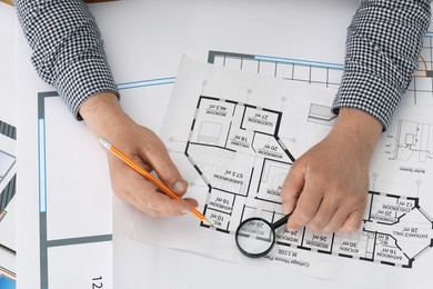 Photo of Architect working with project at table in office, top view