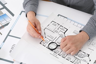 Photo of Architect working with project at table in office, closeup