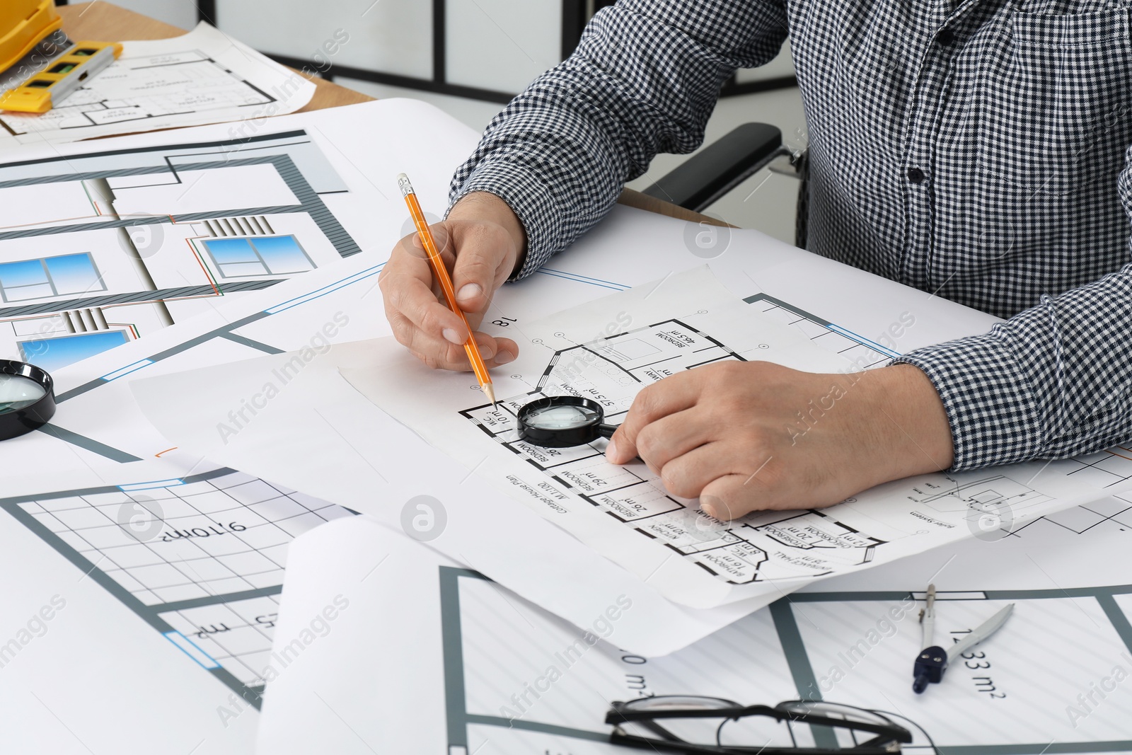 Photo of Architect working with project at table in office, closeup