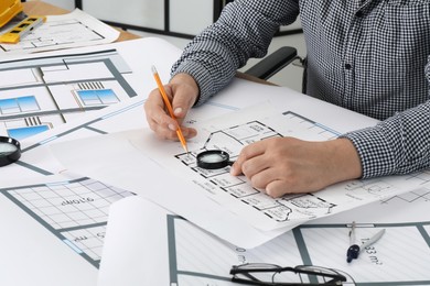 Photo of Architect working with project at table in office, closeup