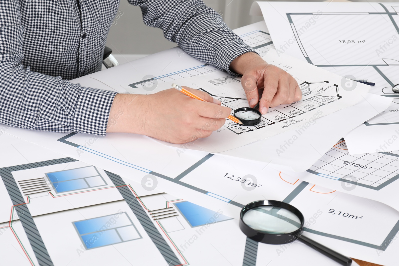 Photo of Architect working with project at table in office, closeup