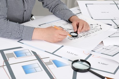 Photo of Architect working with project at table in office, closeup