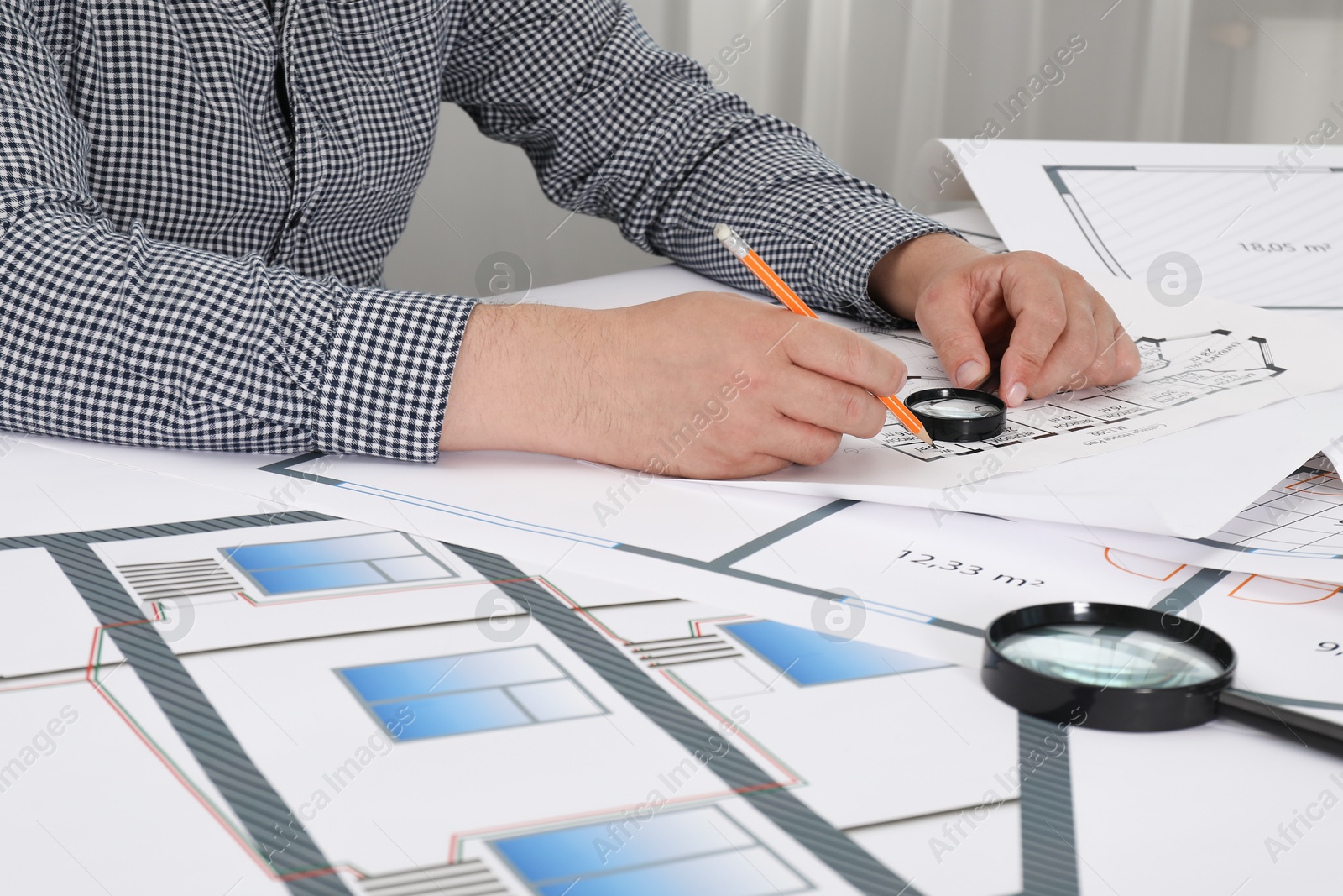 Photo of Architect working with project at table in office, closeup