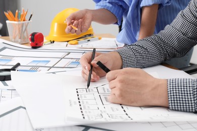 Photo of Architects working with project at table in office, closeup