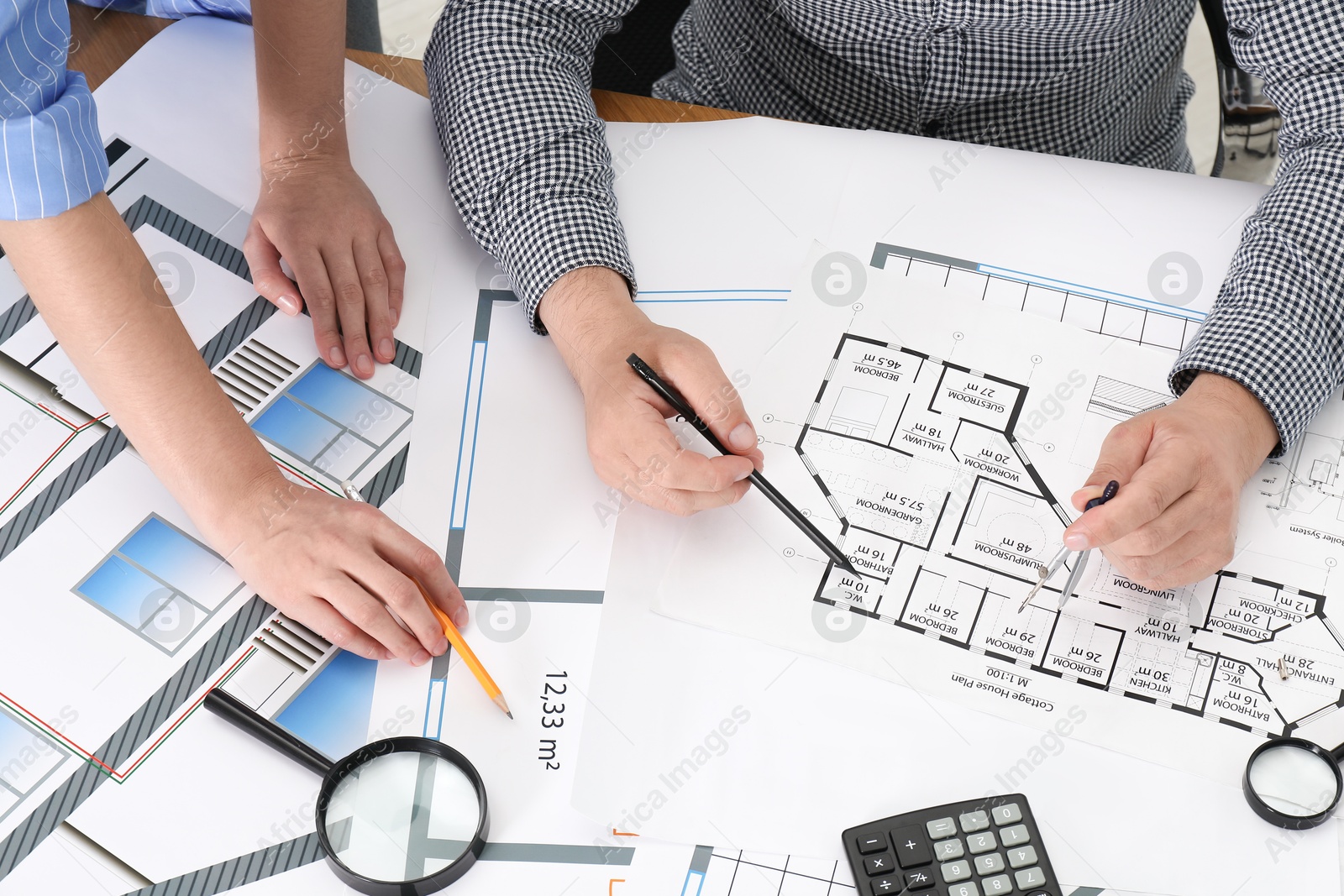 Photo of Architects working with project at table in office, top view