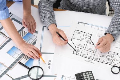 Photo of Architects working with project at table in office, top view