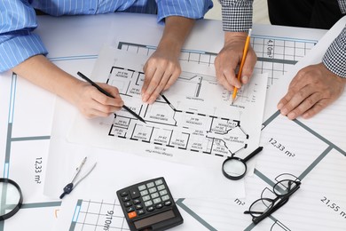 Photo of Architects working with project at table in office, top view