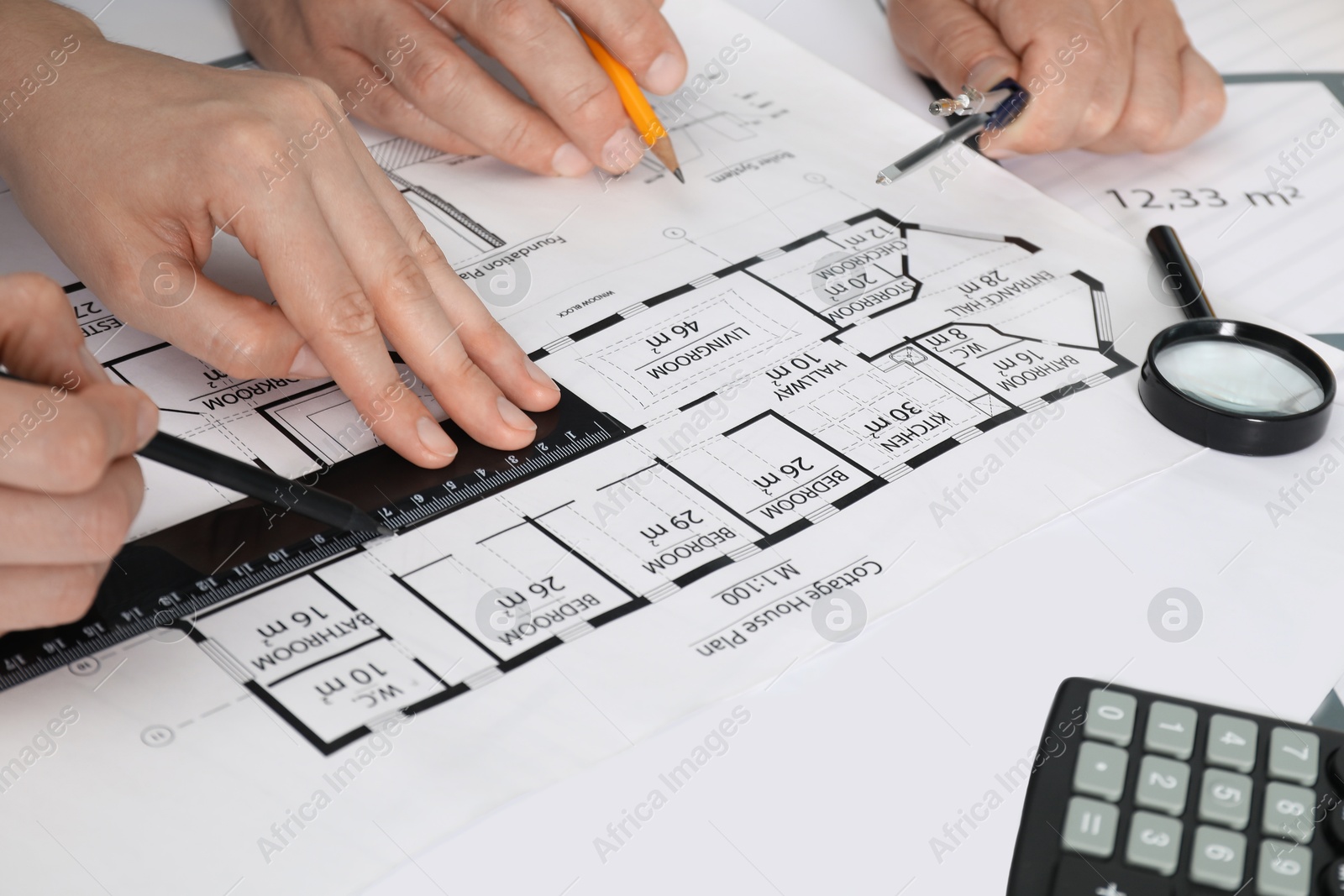 Photo of Architects working with project at table in office, closeup