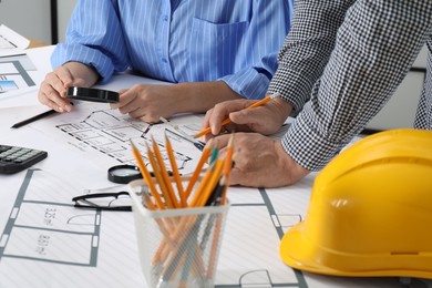 Architects working with project at table in office, closeup