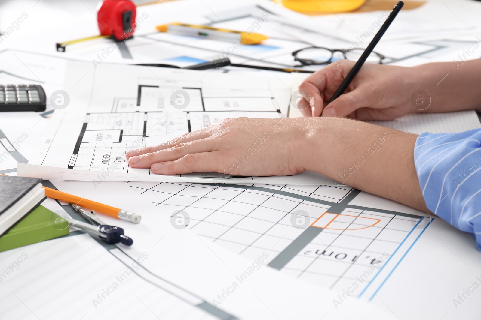 Photo of Architect working with project at table in office, closeup