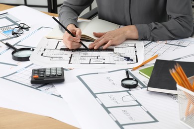 Photo of Architect working with project at table in office, closeup