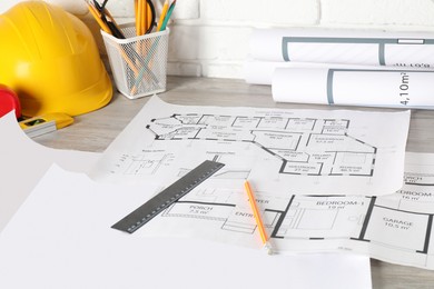 Photo of Different engineering drawings and tools on wooden table