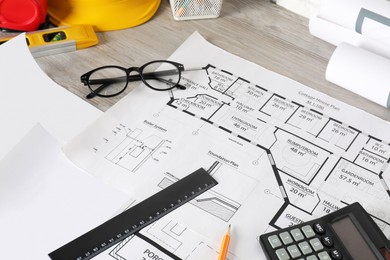 Photo of Different engineering drawings and tools on wooden table