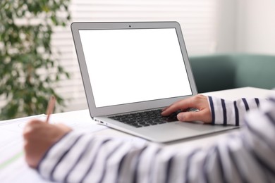 Photo of Woman working at table with laptop in office, closeup. Mockup for design