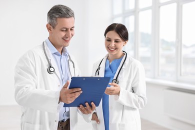 Photo of Healthcare workers with clipboard in hospital. Medical service