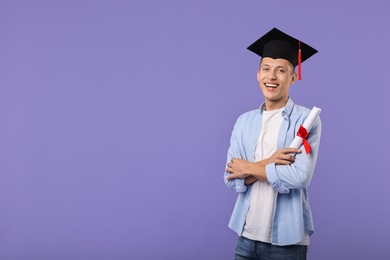 Photo of Happy student with diploma after graduation on violet background. Space for text