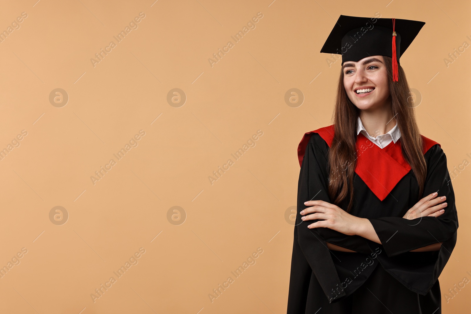 Photo of Happy student with crossed arms after graduation on beige background. Space for text