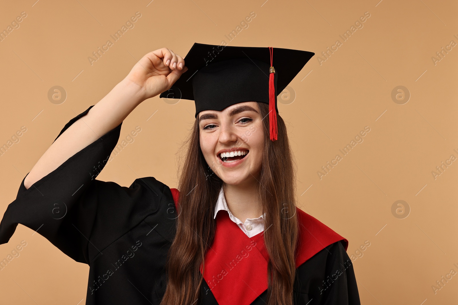 Photo of Happy student after graduation on beige background