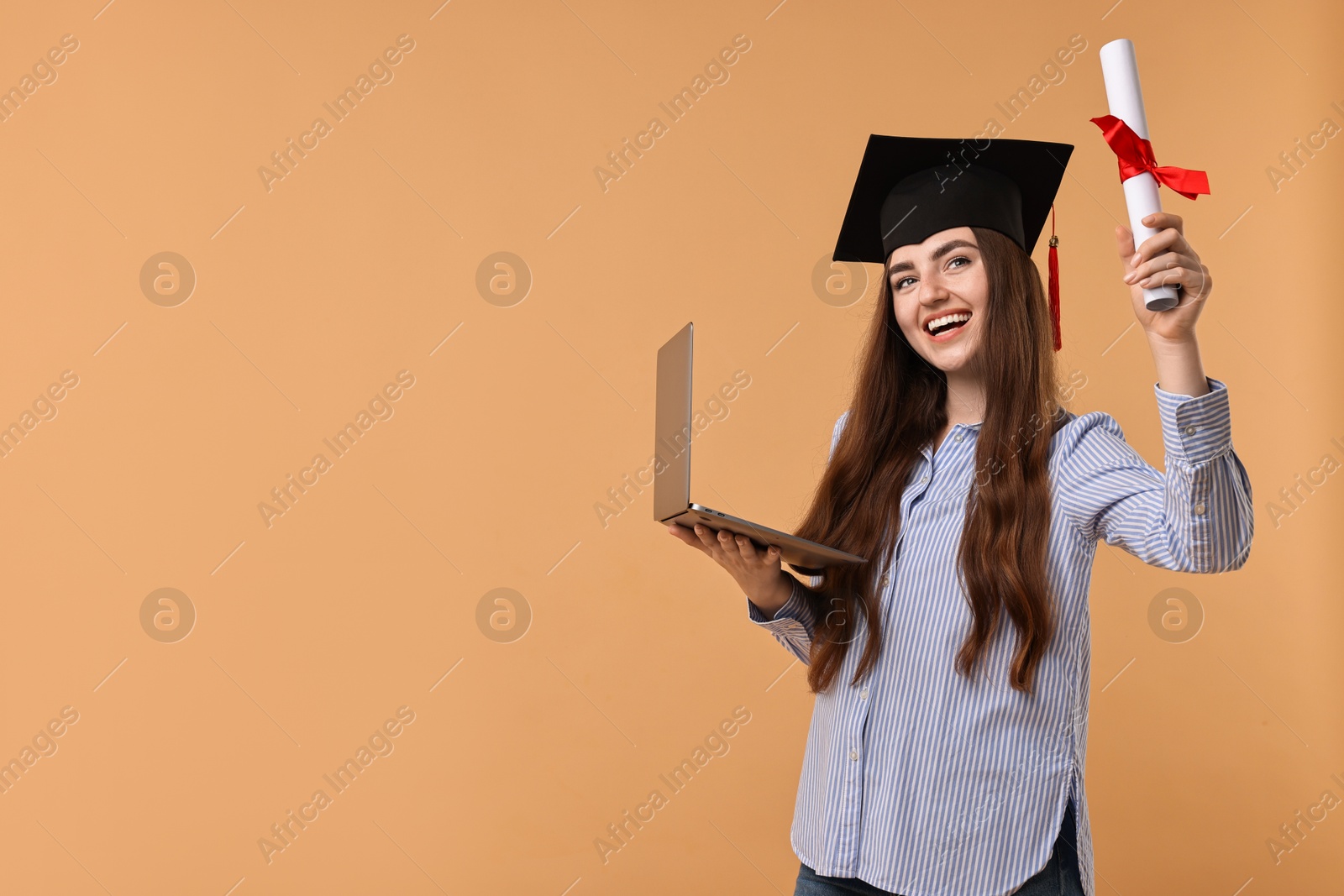 Photo of Happy student with diploma and laptop after graduation on beige background. Space for text