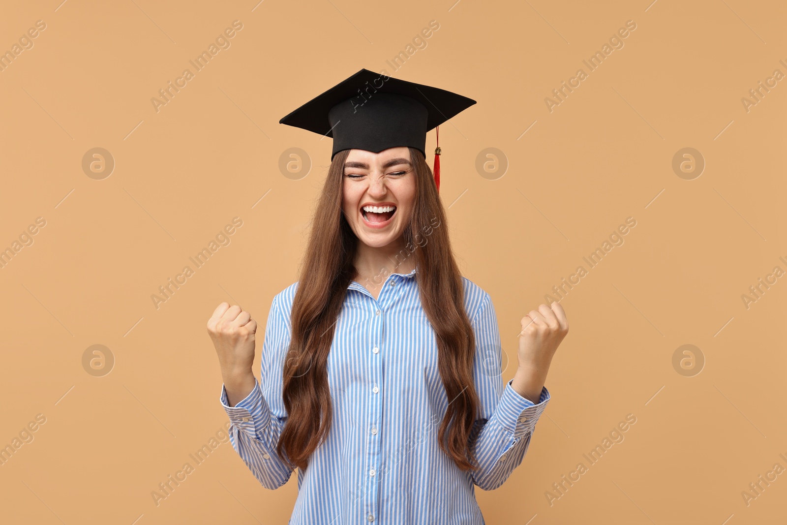 Photo of Happy student after graduation on beige background