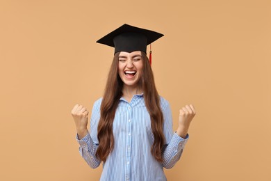 Photo of Happy student after graduation on beige background