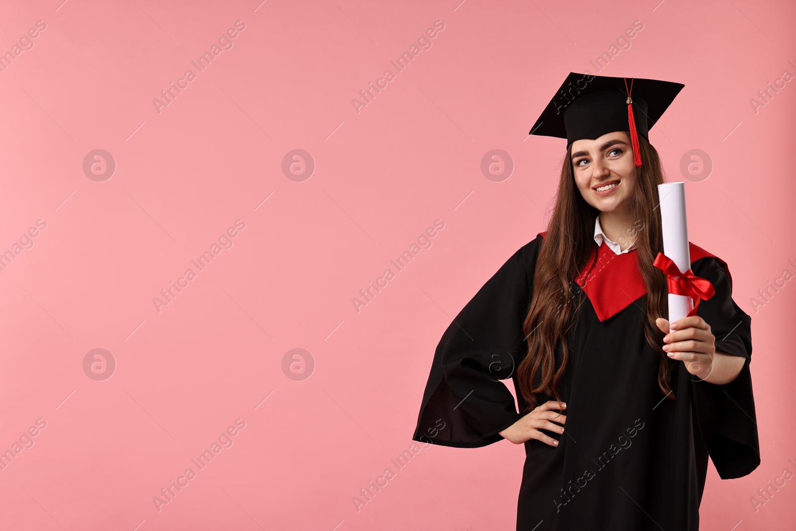 Photo of Happy student with diploma after graduation on pink background. Space for text