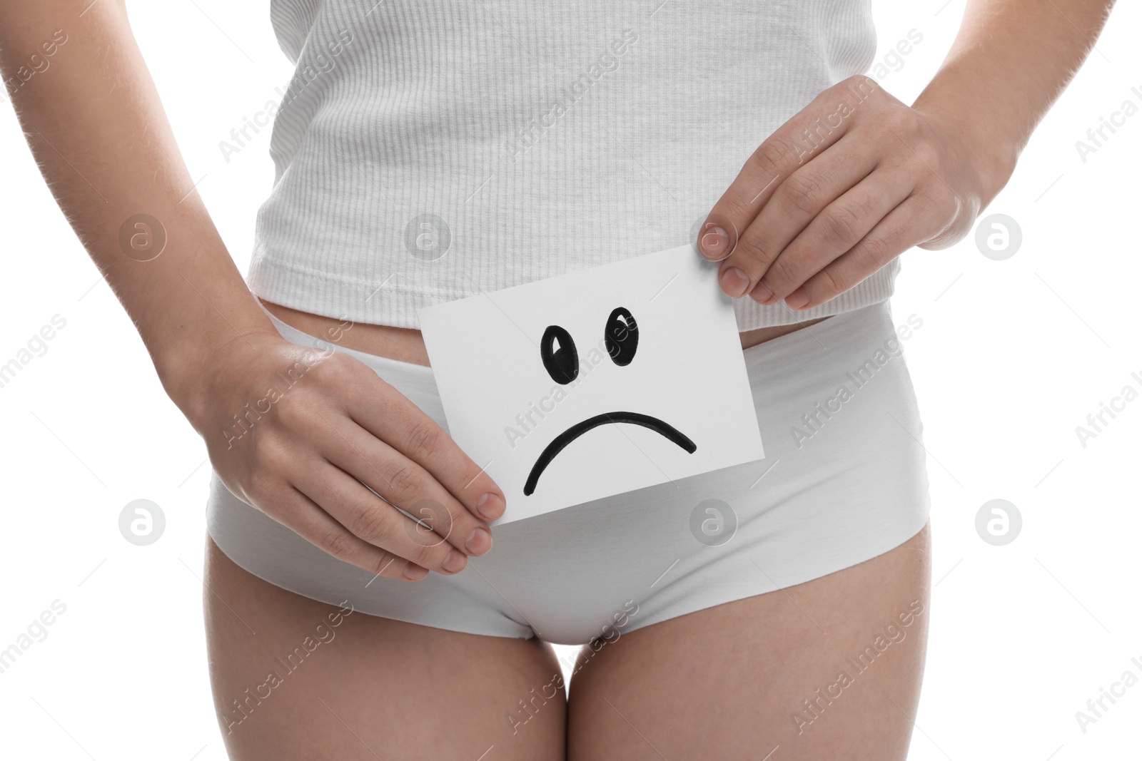 Photo of STD (sexually transmitted disease). Woman holding sticky note with drawn sad face on white background, closeup