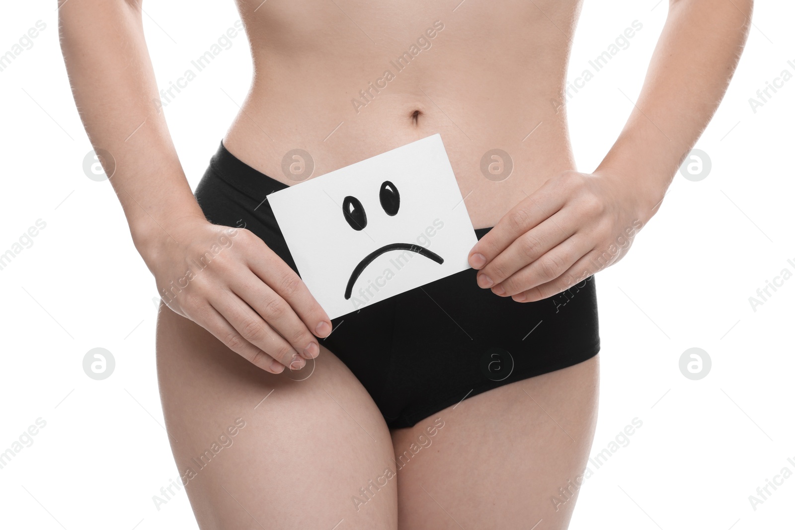 Photo of STD (sexually transmitted disease). Woman holding sticky note with drawn sad face on white background, closeup