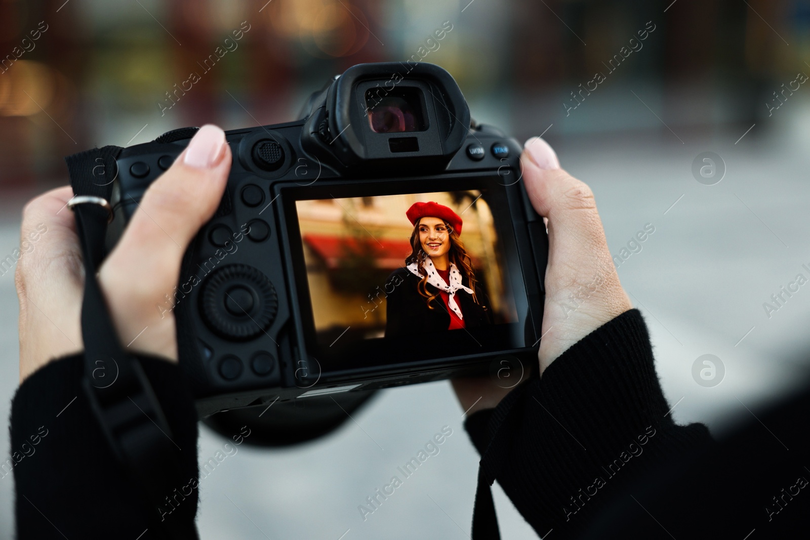 Photo of Professional photographer with digital camera outdoors, closeup