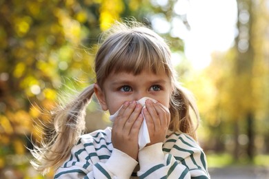 Photo of Little girl with runny nose in park