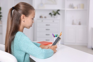 Photo of Girl with correct posture using smartphone at white desk indoors