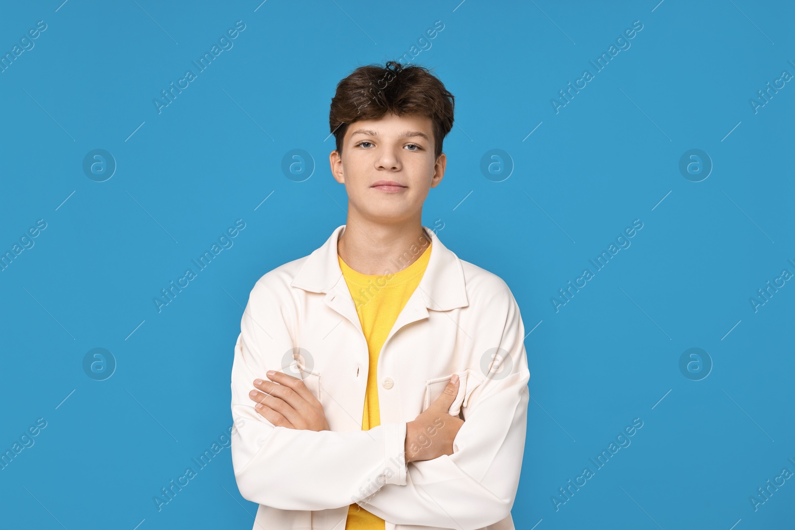 Photo of Portrait of teenage boy on light blue background