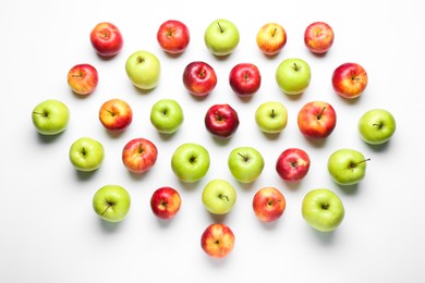 Red and green apples on white background, flat lay