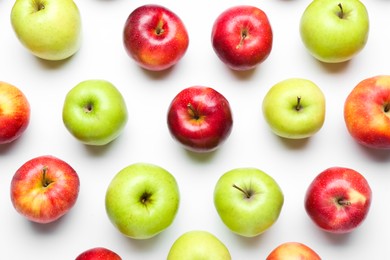 Red and green apples on white background, flat lay