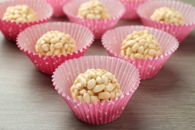 Tasty puffed rice balls on wooden table, closeup