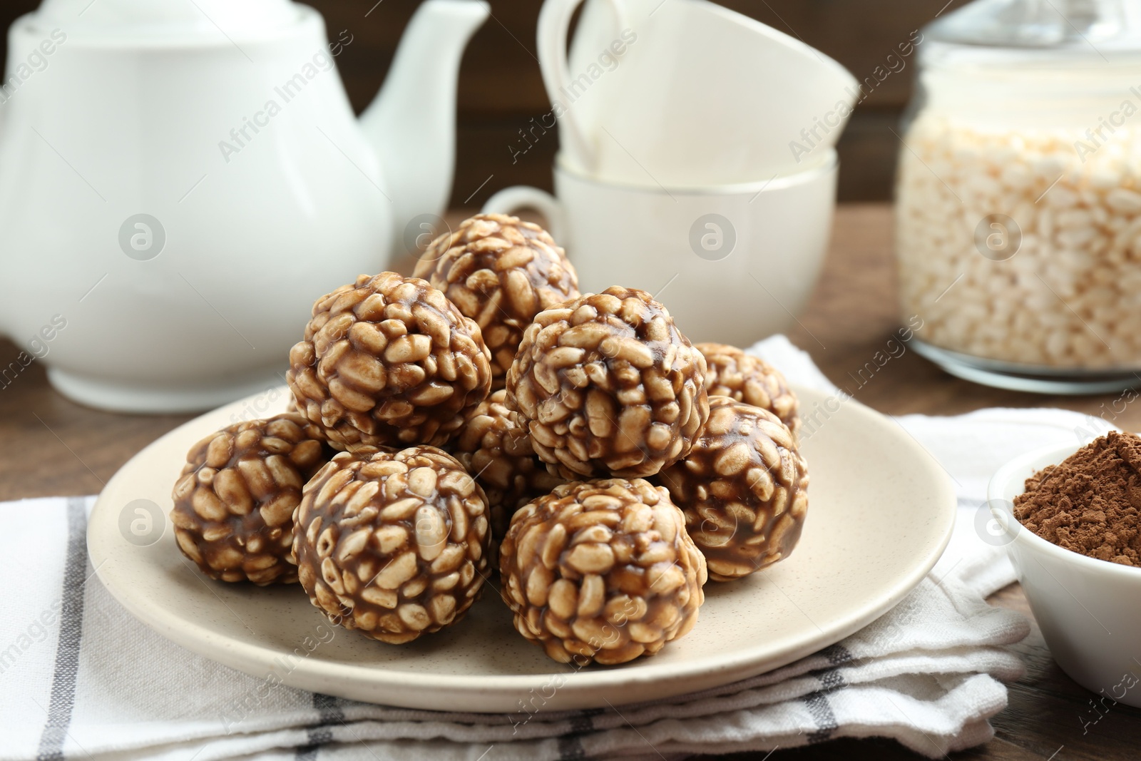 Photo of Tasty chocolate puffed rice balls served on table, closeup