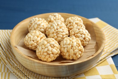 Photo of Tasty puffed rice balls on table, closeup