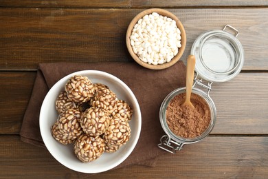 Photo of Tasty chocolate puffed rice balls and ingredients on wooden table, flat lay