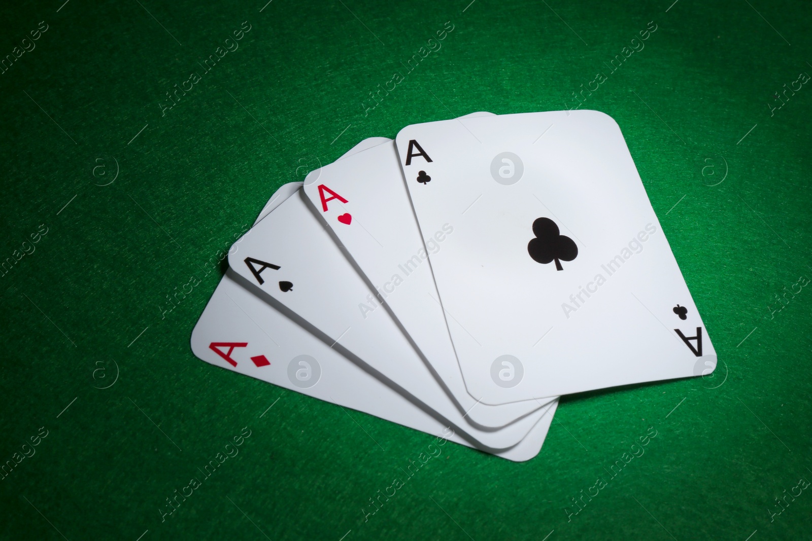 Photo of Poker game. Playing cards on green table