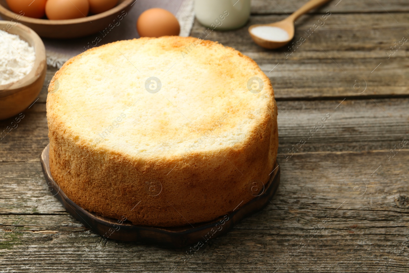 Photo of Tasty fresh sponge cake on wooden table