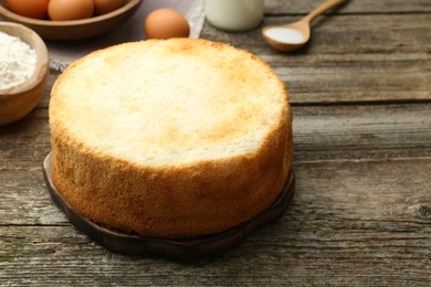 Photo of Tasty fresh sponge cake on wooden table