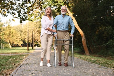 Photo of Senior couple with walking frame in park