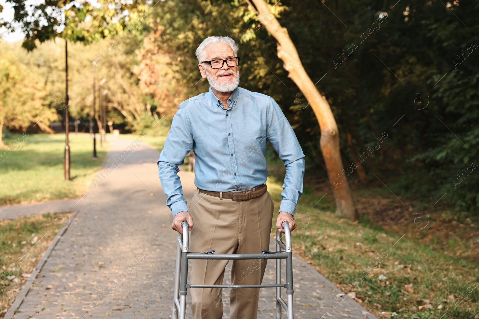 Photo of Senior man with walking frame in park