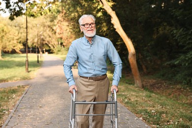 Photo of Senior man with walking frame in park