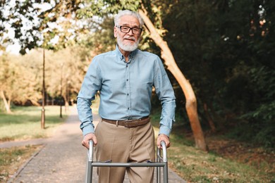 Photo of Senior man with walking frame in park