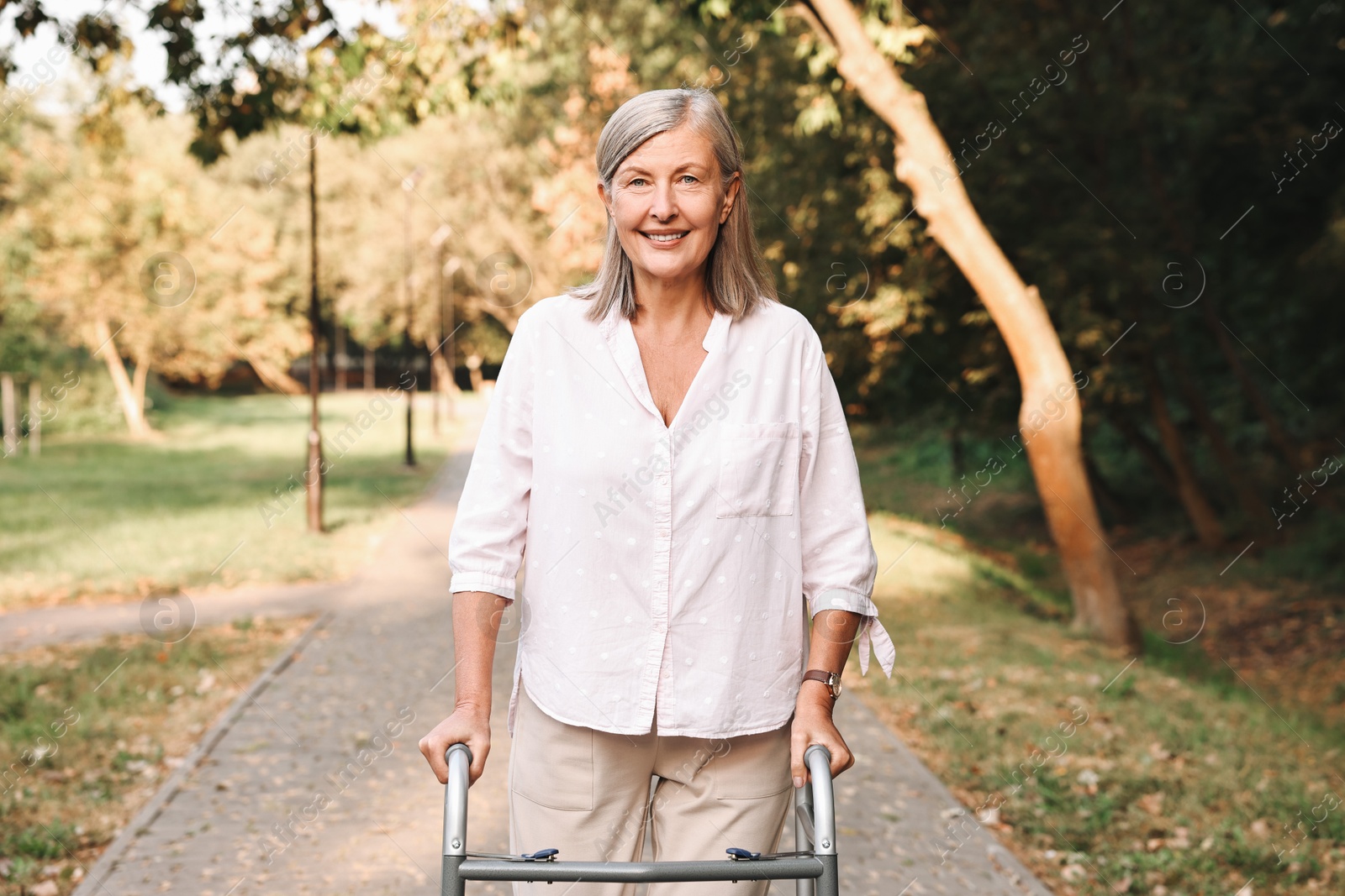 Photo of Senior woman with walking frame in park