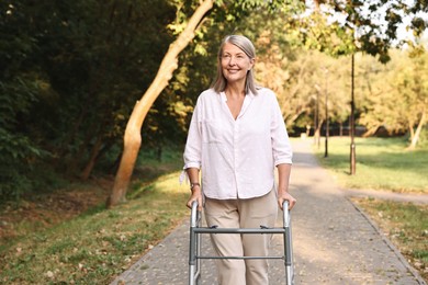 Photo of Senior woman with walking frame in park