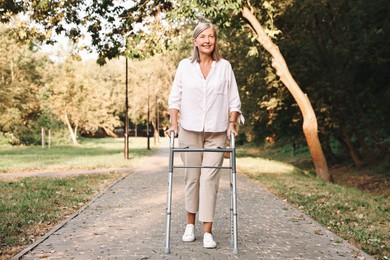 Photo of Senior woman with walking frame in park