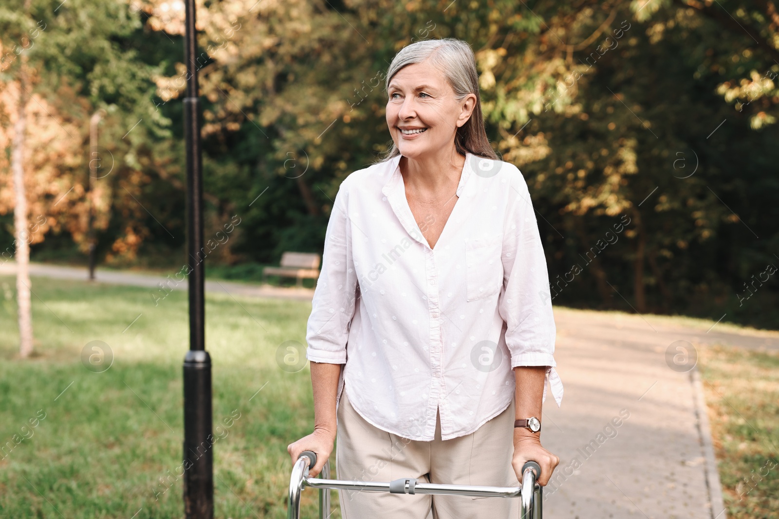 Photo of Senior woman with walking frame in park