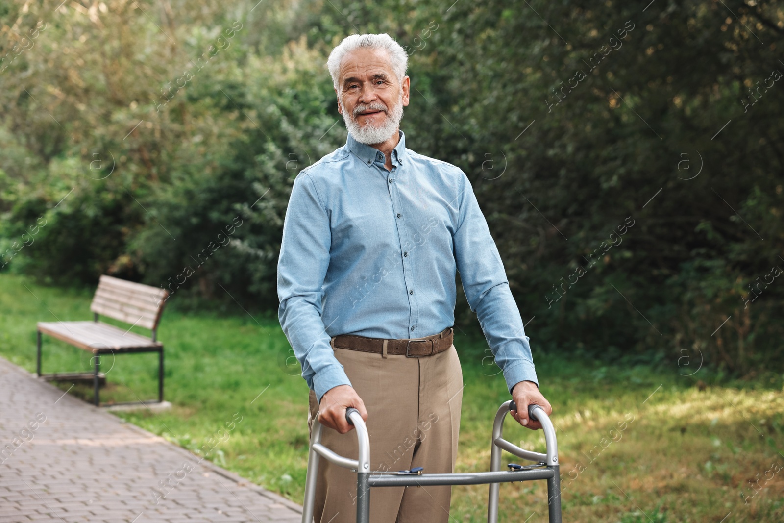 Photo of Senior man with walking frame in park